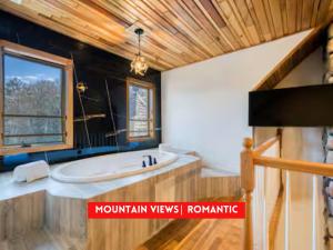 a bathroom with a tub and a sink and a window at The Haüs Windham - Spacious Suites, Hot Tub, Mountain Views! in Windham +47 photos