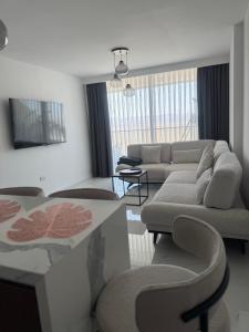 a living room with a couch and a table at Grand Sapphire Casino 12 in Iskele