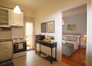 a room with a kitchen and a bedroom with a bed at Cozyhome 4 ILISIA in Thessaloniki