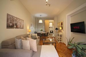 a living room with a couch and a table at Cozyhome 4 ILISIA in Thessaloniki