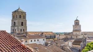 an overview of a city with two towers and roofs at Hôtel Amphithéâtre in Arles