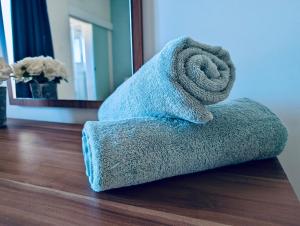a towel sitting on the floor in a room at Sunset Haven Manikata - Walking distance to Golden Bay in Manikata