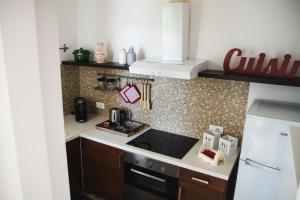 a kitchen with a sink and a stove top oven at Villa Catia in Alberobello +22 photos