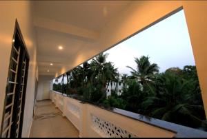 a balcony with a view of palm trees at Paradise Mystic Tones in Auroville