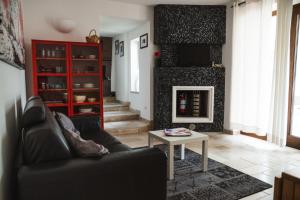 a living room with a couch and a fireplace at Villa Catia in Alberobello