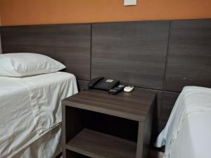 Rúm í herbergi á Ônix Inn Hotel Cravinhos