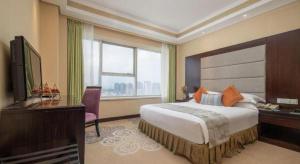 TV a/nebo společenská místnost v ubytování Yiwu Yimei Plaza Hotel