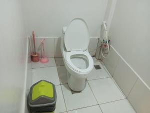 a bathroom with a toilet with a litterbox next to it at El Nido mama hostel in El Nido +38 photos