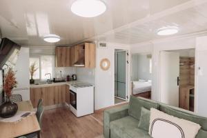 a kitchen and living room with a couch and a table at Erato's Cottage in Plaka