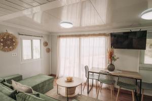 a living room with a table and a couch at Erato's Cottage in Plaka