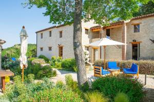 a patio with a table and chairs and an umbrella at Agriturismo Montecolombo by Il Ritorno in Sirolo