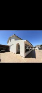 a white building with a ramp in a parking lot at Casa Marina Maltese via ucca marina SANTA MARIA DEL FOCALLO ISPICA in Santa Maria Del Focallo