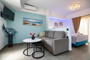 a living room with a couch and a table at Haraki Bliss in Haraki