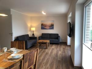 a living room with a couch and a table at Feriendomizil-SeeSand-2 in Gammendorf
