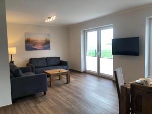 a living room with a couch and a table at Feriendomizil-SeeSand-2 in Gammendorf