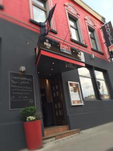 a restaurant with a sign on the side of a building at Hotel Hoppe in Witten