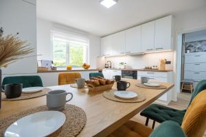a kitchen and dining room with a wooden table at Apartma pod macesnom in Jesenice