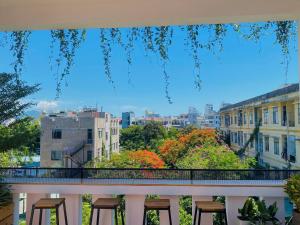a group of stools sitting on a balcony with a view at Pina Home in Da Nang