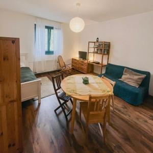a living room with a table and a couch at Bolgárkert Family House in Budapest