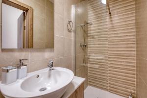a bathroom with a sink and a shower at New! Modern Studio in central Malta by SF Homes in Msida