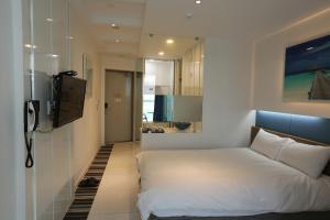 Postel nebo postele na pokoji v ubytování Hamdeok Beach Stay Jeju