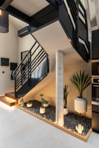 a room with potted plants and a staircase at Host Inn Wow House in Lyon +20 photos