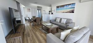 a living room with a couch and a table at Broadbeach Holiday Apartments in Gold Coast +71 photos