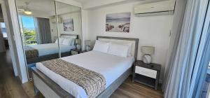 a hotel room with two beds and a window at Broadbeach Holiday Apartments in Gold Coast