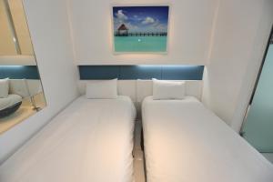 Postel nebo postele na pokoji v ubytování Hamdeok Beach Stay Jeju