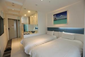 Postel nebo postele na pokoji v ubytování Hamdeok Beach Stay Jeju