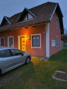 a car parked in front of a house at Apartma Dian in Mostec