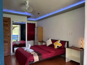 a bedroom with a large bed with a red blanket at Jlb resort and tours,Guest House in Valdez +40 photos