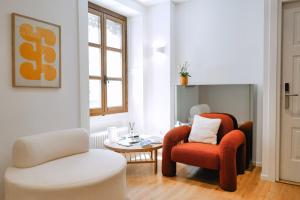 a living room with two chairs and a table at Rhodania Boutique Hôtel in Geneva