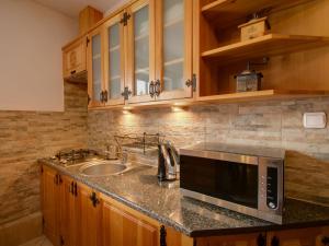 a kitchen with a sink and a microwave at Apartament Krupówki 73 - 2-7 person in Zakopane