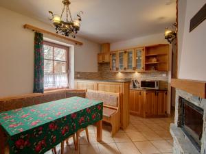 a kitchen with a table and a fireplace at Apartament Krupówki 73 - 2-7 person in Zakopane