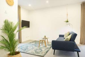 a living room with a blue couch and a table at Achterdeck in Eckernförde