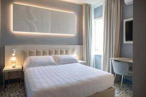 Postel nebo postele na pokoji v ubytování Grand Hotel