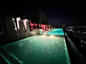 a swimming pool on top of a building at night at Wanderlust Retreat Studio by Iconic Regency in Bayan Lepas