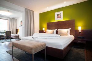 a bedroom with a large bed and a green wall at Apart-Garni Innerwiesn in Mayrhofen