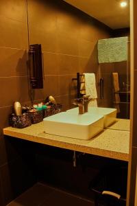 a bathroom counter with a sink and a mirror at Modern City Loft, 2BR Split, 2 Levels & Parking in Auckland
