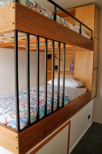 two bunk beds in a room with a bed at Modern City Loft, 2BR Split, 2 Levels & Parking in Auckland