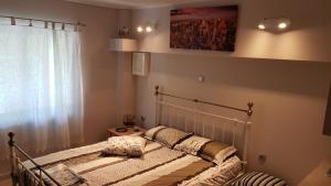 a bed in a room with a window at Konstantinos Apartments in Kholargós