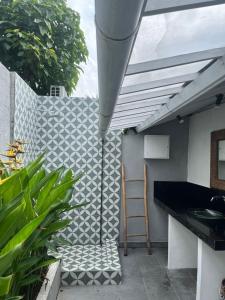 a kitchen with a sink and a ladder on a patio at Villa Louise in Badung