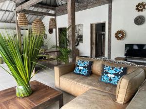 a living room with a couch and a table at Villa Louise in Badung +1 photo