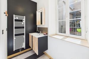 Un baño con lavabo y ventana. en Chic T2 rénové au cœur de Clermont-Ferrand à 2 min de Jaude !, en Clermont-Ferrand 9 fotos más