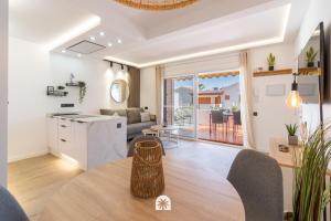 a kitchen and living room with a table in a room at Mediterranean Way - Punta Prima 17 in La Pineda