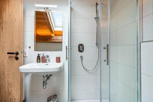 a bathroom with a sink and a shower at Ferienwohnung Falkenstein in Inzell +19 photos