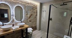 a bathroom with two sinks and a shower at Palleira da Meiroá in Esgos +21 photos