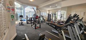 a gym with treadmills and ellipticals in a room at Broadbeach Holiday Apartments in Gold Coast