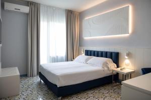 Postel nebo postele na pokoji v ubytování Grand Hotel